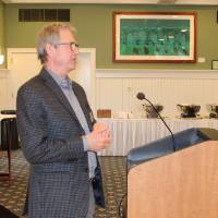 Faculty next to podium